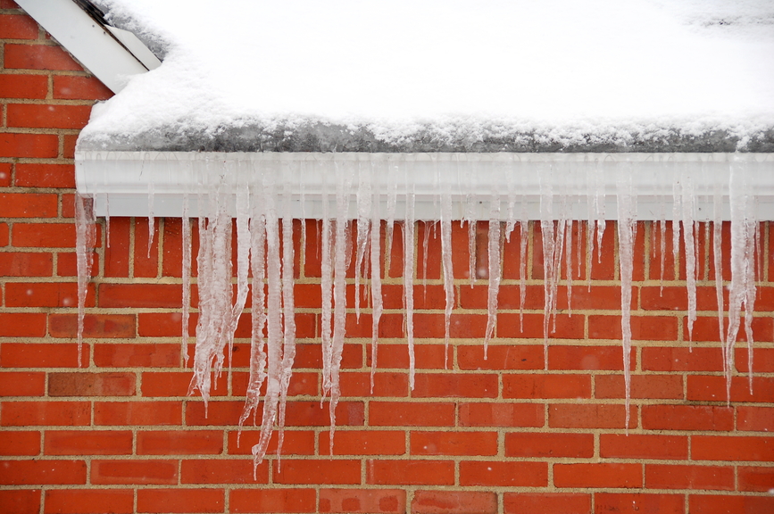 Icicles hanging from a home's roof signal the presence of an ice dam