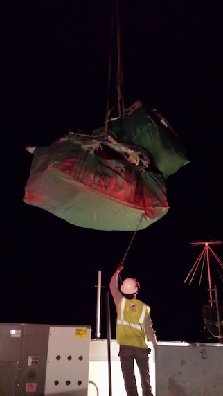 Removing Old Roofing Material from Airport Control Tower by Crane at Night