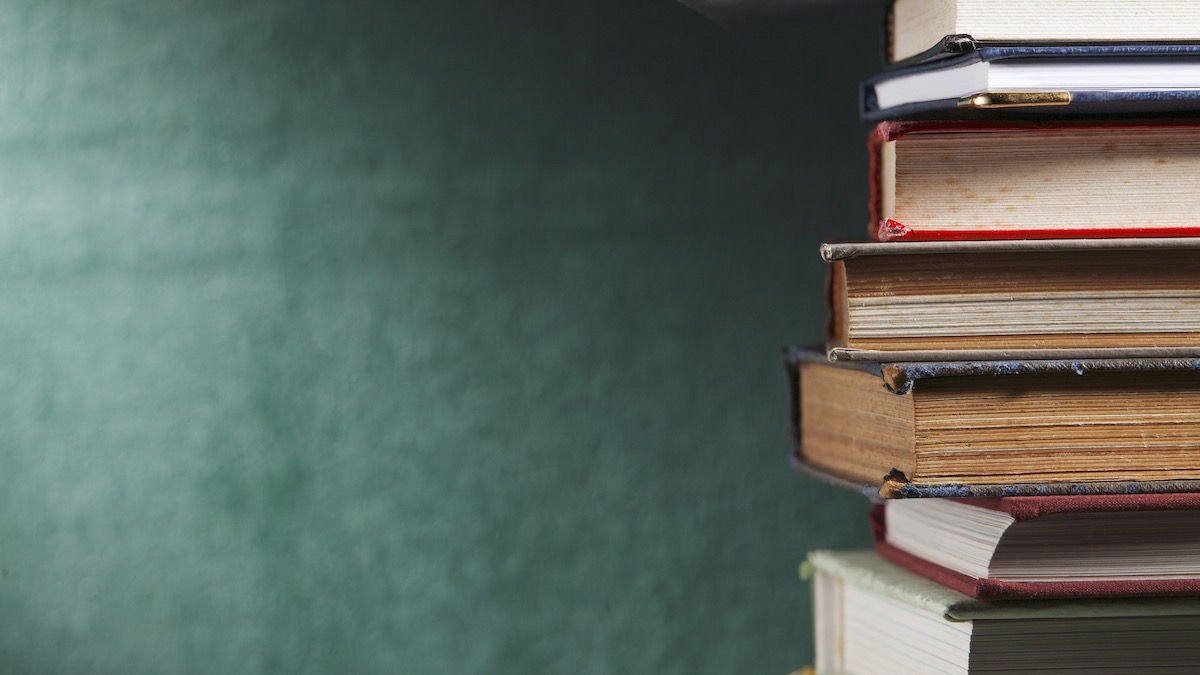 Stacked schoolbooks in front of a green chalkboard, Weippe, ID