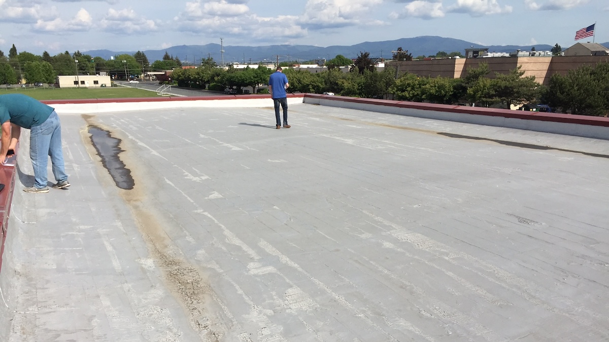 Old Commercial Hot Tar Flat Roof With Deteriorated Coating